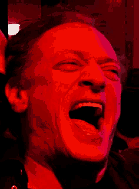a close up of a man 's face with his mouth wide open