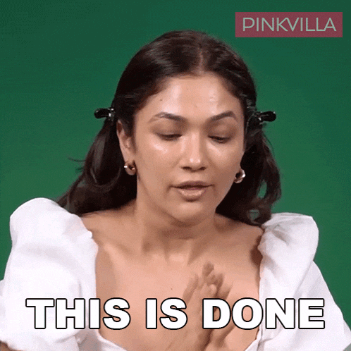 a woman in a white top is making a gesture that says this is done