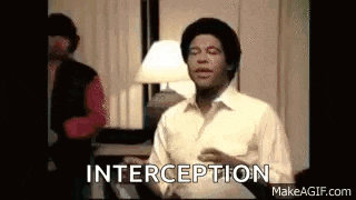 a man in a white shirt is dancing in a room with the words `` interception '' written above him .