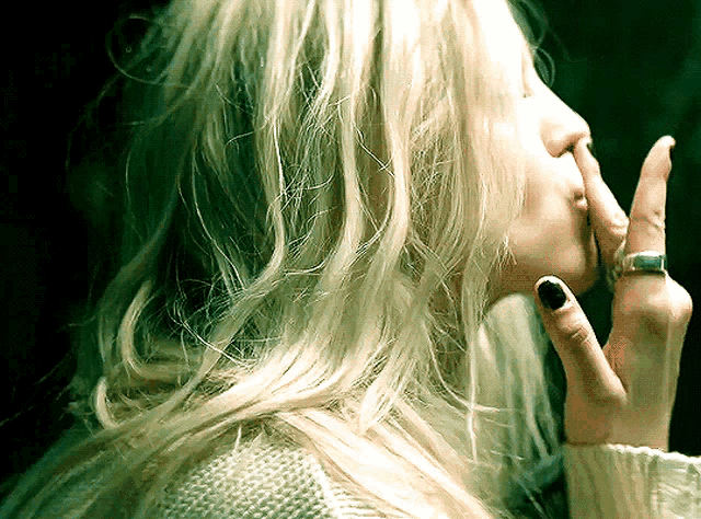 a woman with a ring on her finger is covering her nose
