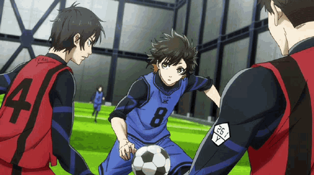 a soccer player with the number 8 on his jersey dribbles the ball