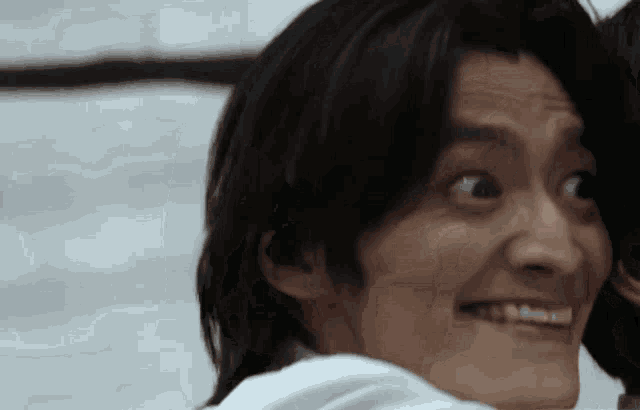 a close up of a man making a funny face with his eyes closed .