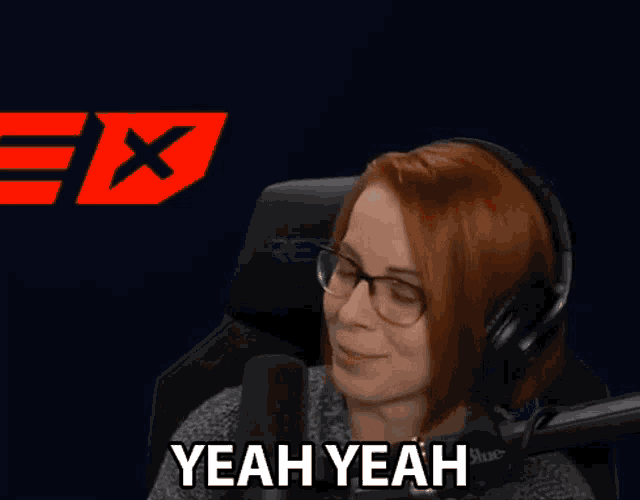a woman wearing glasses and headphones says " yeah yeah "