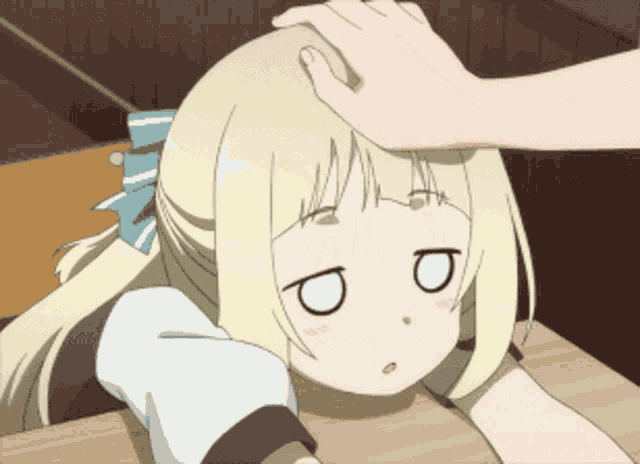 a girl with blonde hair has her eyes closed and her head is being touched