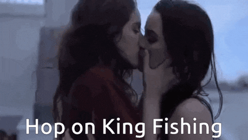 two women are kissing each other with the words `` hop on king fishing '' written above them .