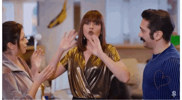 a man and two women are standing next to each other with a banana in the background