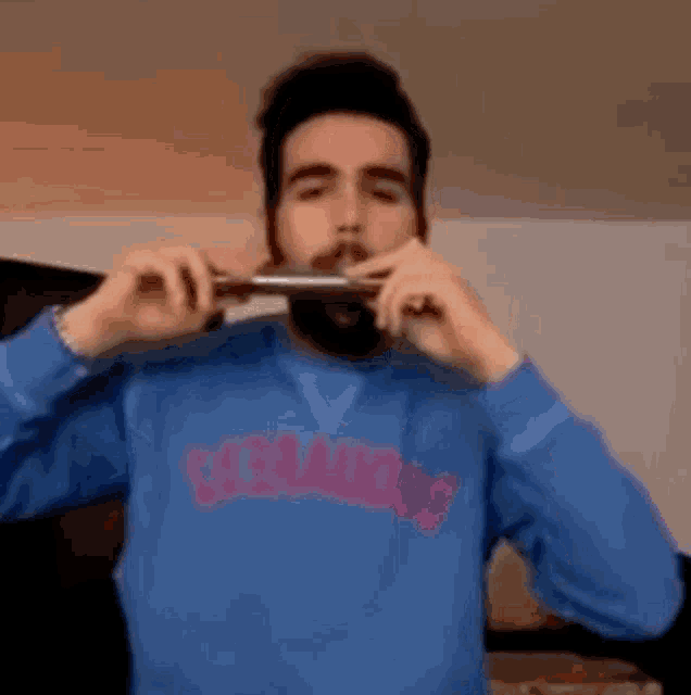 a man wearing a blue sweatshirt that says ' casamigos ' on it