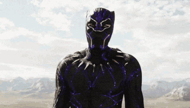 a man in a black and purple superhero costume