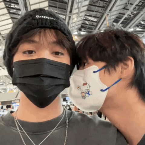 two people wearing face masks one of which has a hello kitty design on it