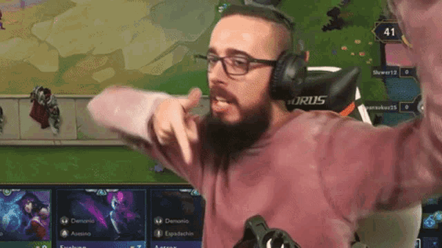 a man wearing headphones and a pink shirt with the word forus on the back