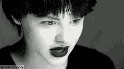 a black and white photo of a woman 's face with a tear coming out of her eye .