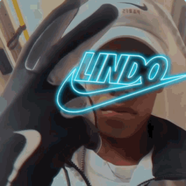 a person wearing a hat and a glove with the word lindo on it