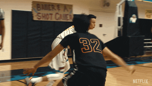 a basketball player with the number 32 on his back dribbles the ball