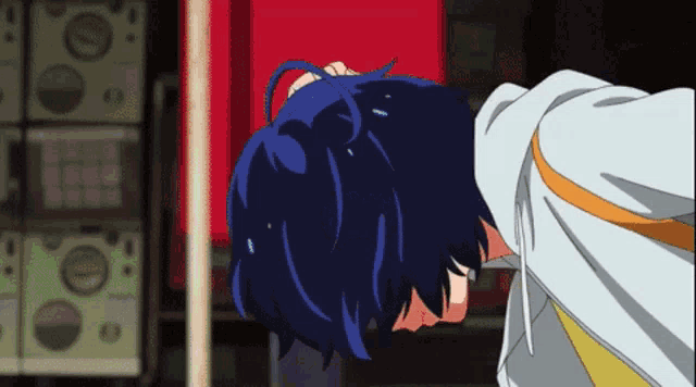 a person with blue hair is laying on their back in a room
