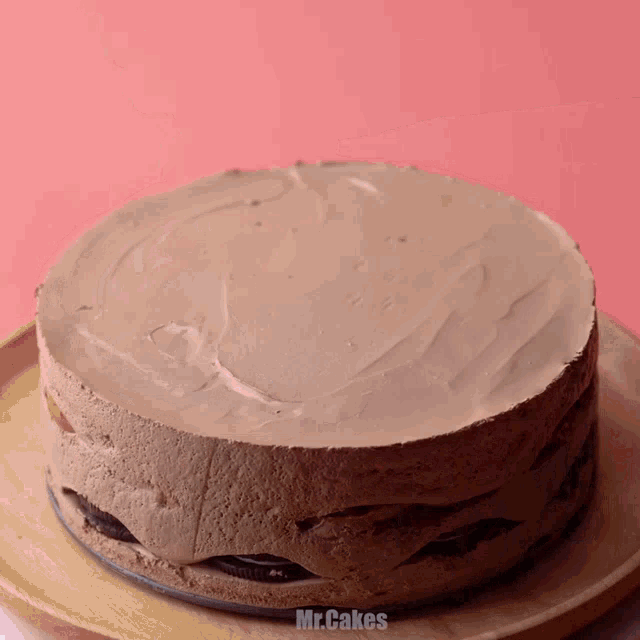 a cake on a wooden plate that says mr.cakes