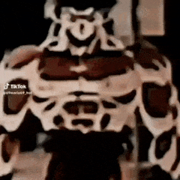 a close up of a person 's torso with muscles and a face .