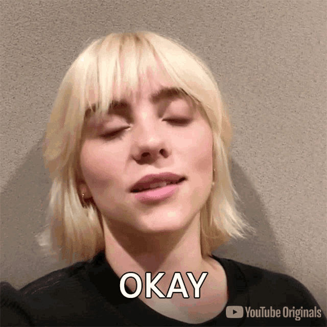 a close up of a woman 's face with okay written on the bottom