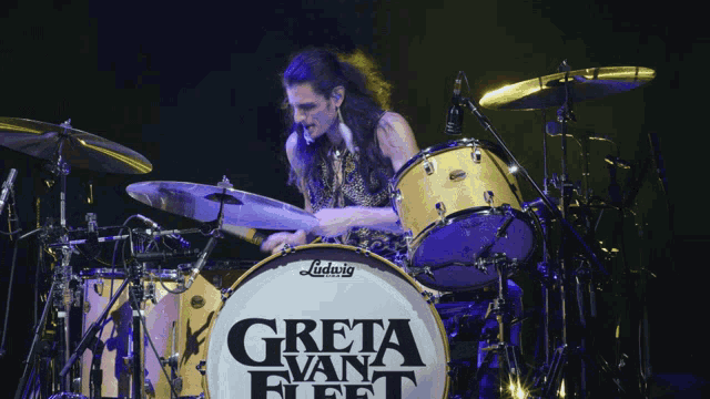 a man playing a drum set that says greta van fleet on it