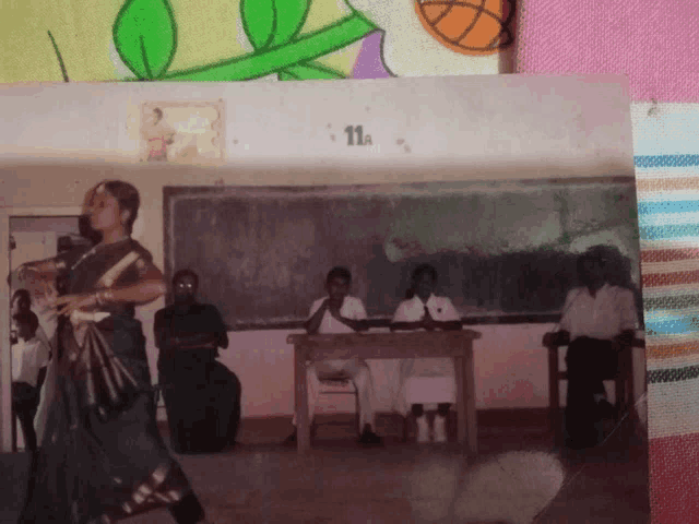 a group of people sitting at a table with the number 11a on the wall above them
