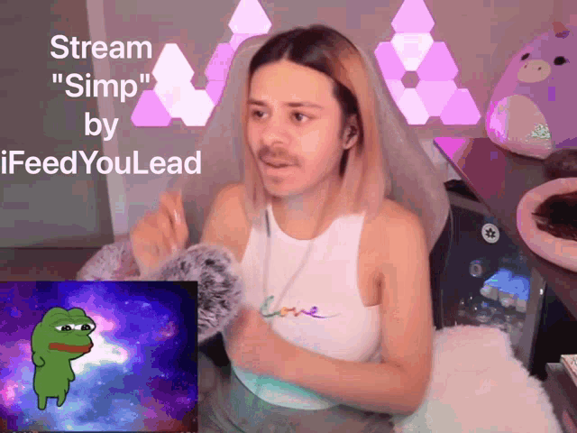 a man sitting in front of a screen that says stream " simp " by ifeedyoulead