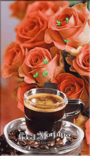 a cup of coffee sits on a saucer next to a bouquet of roses with the words good morning written on the bottom