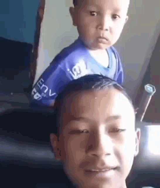 a man is carrying a baby on his back .