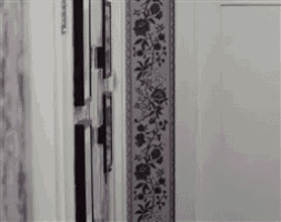 a purple and black floral border is on a white door