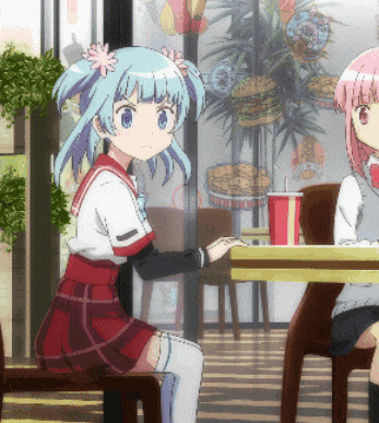 two anime girls sit at a table with a drink