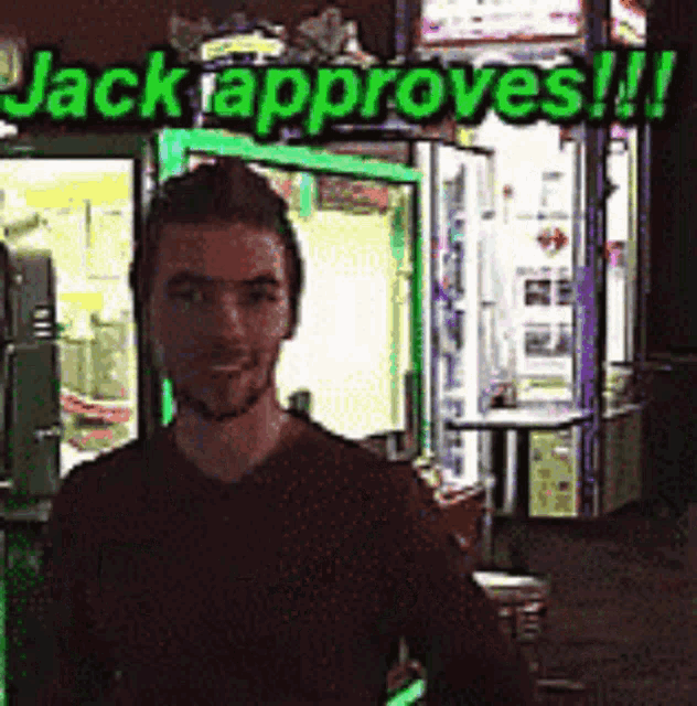 a man stands in front of a sign that says " jack approves "