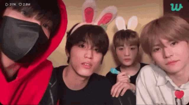 a group of young men wearing bunny ears and masks .
