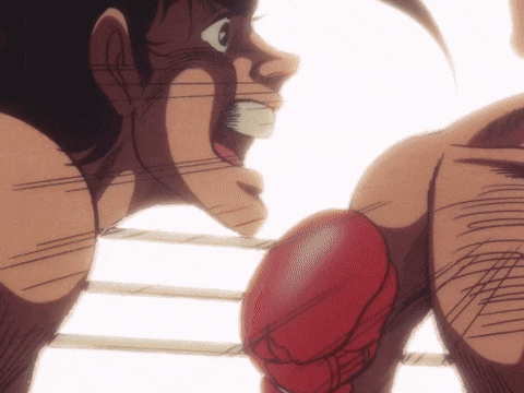 two boxers are fighting in a ring and one has red gloves