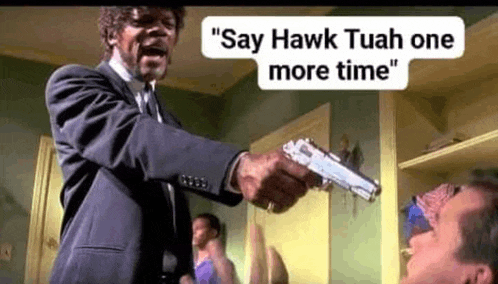 a man in a suit and tie is pointing a gun at another man in a bedroom .