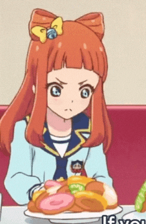 a cartoon girl with red hair is sitting at a table with a plate of food