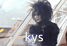 a person with black hair is standing in front of a window with the word kys on it