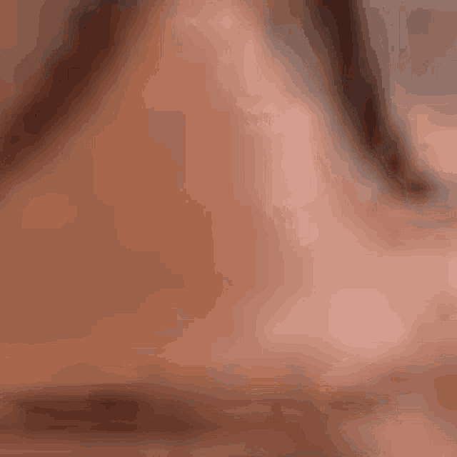 a close up of a woman 's face with a blurry background .