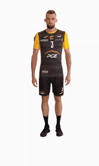 a man wearing a pge shirt and shorts stands in front of a white background