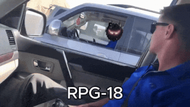 a man is sitting in a car with the words rpg-18 on the bottom right