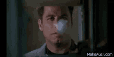 a close up of a man 's face behind a glass door .