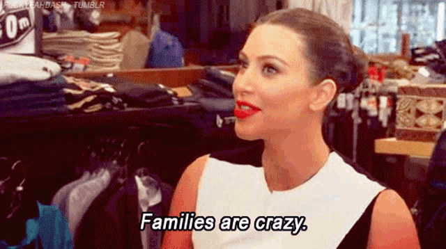 a woman is sitting in a clothing store and says families are crazy .