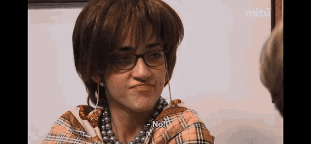 a woman wearing glasses and pearls says no