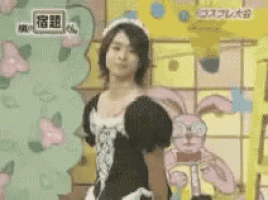 a man in a maid outfit is standing in front of a cartoon rabbit
