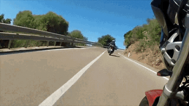 a person is riding a motorcycle on a road