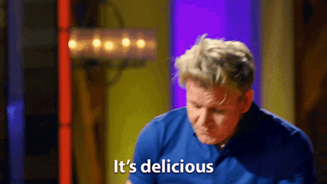 a man in a blue shirt says it 's delicious in white letters