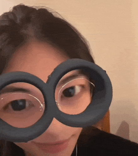 a girl wearing a pair of glasses that look like a pair of minions