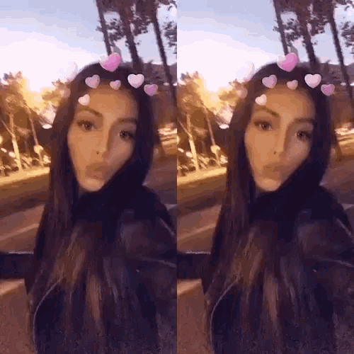 a woman with long hair and hearts on her head