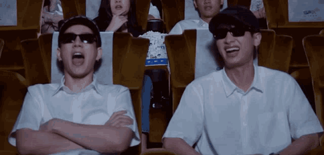 a group of people are watching a movie at the theater