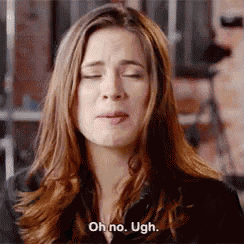 a woman with her eyes closed is making a funny face and saying oh no ugh .