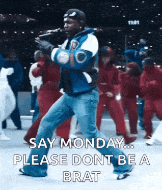 a man singing into a microphone with the words say monday please dont be a brat written below him