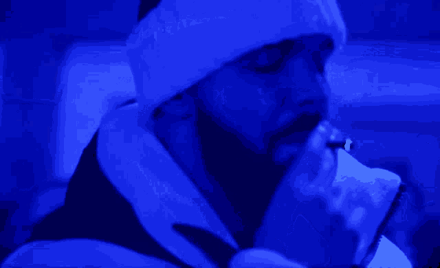 a person with a bandage on their head is smoking a cigarette