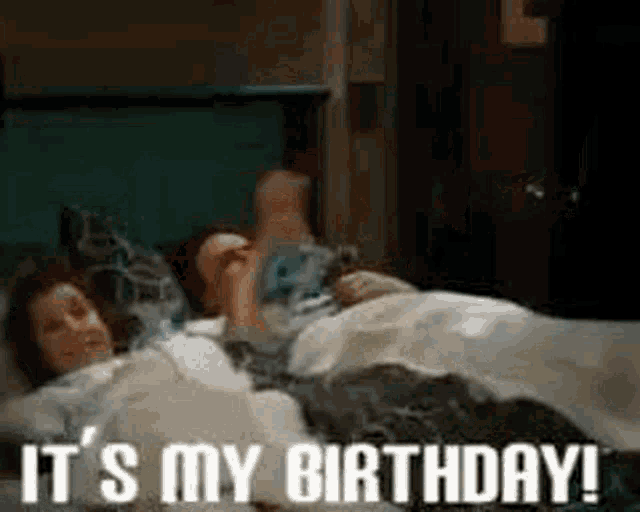 a man and a woman are laying in bed .